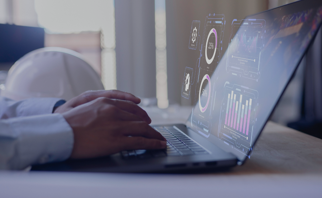 Hands typing on a laptop displaying analytics dashboards – illustrating real-time monitoring in a cloud-native DevOps environment.