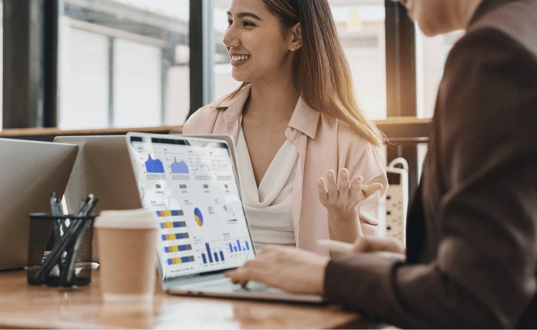 Business meeting discussing AI-powered CRM analytics on a laptop screen