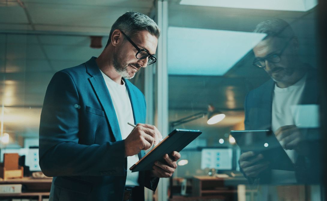 IT professional analyzing sovereign cloud architecture on a tablet in a modern office.
