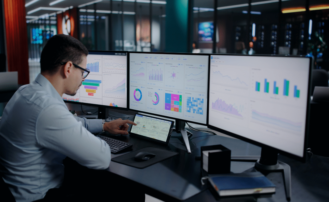 Real-time analytics dashboard in a hybrid cloud environment showing data monitoring and performance metrics on multiple screens.